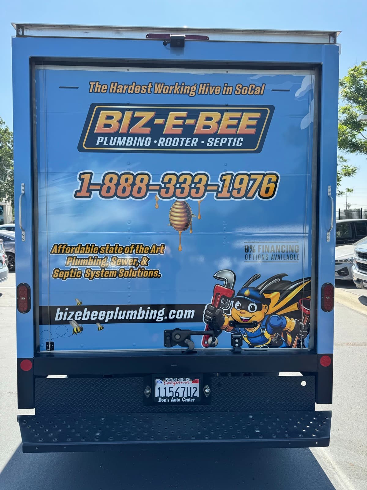 Rear of the Biz-E-Bee truck wrap with tagline, phone number, and 0% financing offer