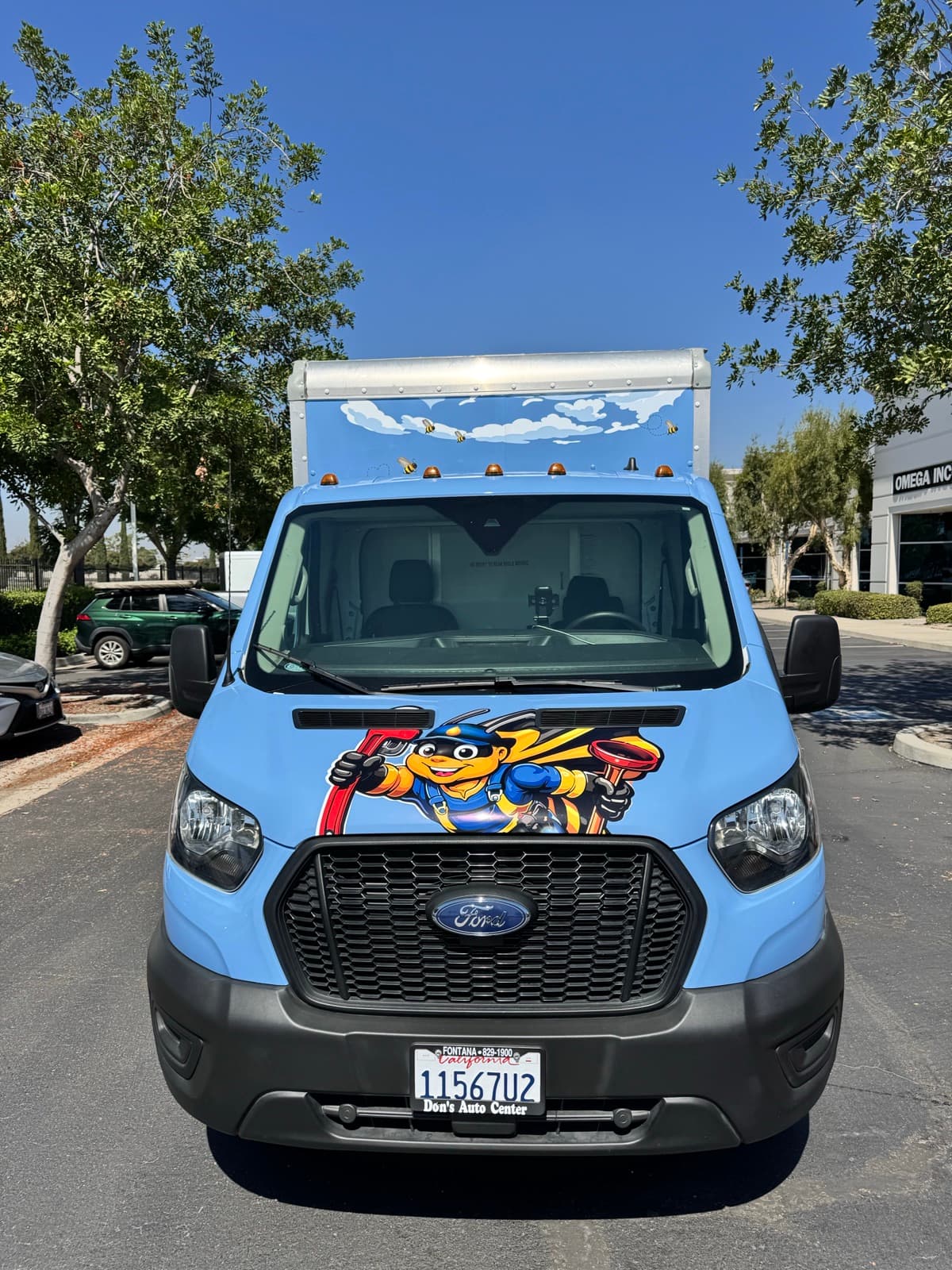 Biz-E-Bee glacier-blue box truck with the bee mascot on the hood